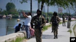 Индийские солдаты охраняют туристов на берегу озера Дал в Шринагаре, контролируемом Индией Кашмире