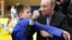 RUSSIA – Russia's Prime Minister Vladimir Putin (R) shows a hold to a young judo wrestler at the Regional Judo Center at the Arena Sports Complex in the Siberian city of Kemerovo, 24 January 2012