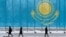 KAZAKHSTAN -- People walk past a gaint Kazakhstan's flag in Astana, March 5, 2019