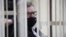  BELARUS -- Viktar Babaryka, former head of Belgazprombank and challenger in the 2020 presidential election, who was jailed on corruption charges, sits inside a defendants' cage before a court hearing in Minsk, February 17, 2021