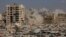FILE PHOTO: Smoke rises as a residential building collapses after an Israeli air strike