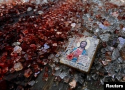 Икона рядом с окровавленными осколками лобового стекла КамАЗа вблизи донецкого аэропорта. 27 мая 2014 года