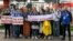 BELARUS -- Journalists of Belarusian TUT.BY media outlet hold banners reading "I don't protest but work", "This is me at work", "Freedom for journalists!", from left to right, as they stand in front of police station in Minsk, September 2, 2020