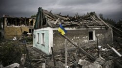 UKRAINE – Ukraіnian flag in front of a partially destroyed building in Irpin, Kyiv region, June 16, 2022